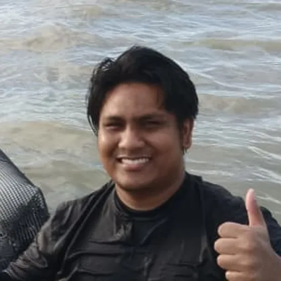 Muin working an oyster line, chest-deep in the water